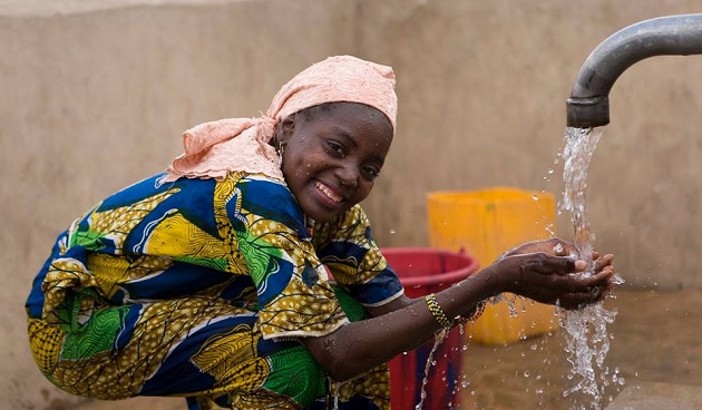 Woman sitting at a water fountain